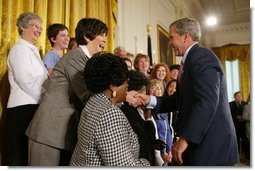 President George W. Bush greets breast cancer survivors at a reception for the National Race for the Cure in the East Room of the White House on April 21, 2004. White House photo by Paul Morse.
