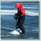 LTER field staff drilling hole through ice