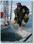 James Osse, a University of Washington field engineer, skims water at field site
