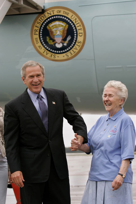 President George W. Bush meets USA Freedom Corps Greeter Grace McCarthy, 83, upon his arrival in Marquette, Mich., Tuesday, July 13, 2004. Ms. McCarthy has volunteered more than 4,000 hours with local groups, including the Retired and Senior Volunteer Program in Marquette. White House photo by Eric Draper.
