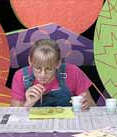 Girl blowing bubbles onto paper