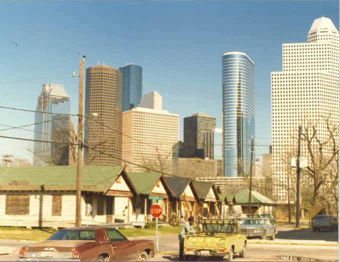 Picutre of Houston inner city neighborhood with downtown skyscrapers in the background