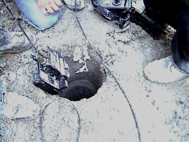 Photo of robot entering sewer
