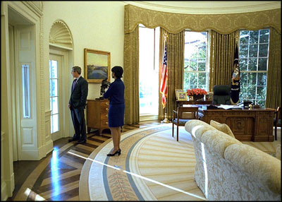 President George W. Bush talks alone with Dr. Condoleezza Rice in the Oval Office Nov. 27, 2002.