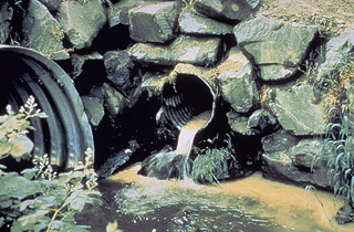 photo of pipes draining into a ditch or stream
