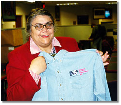 NSF staff member receives her NSF50 denim shirt.